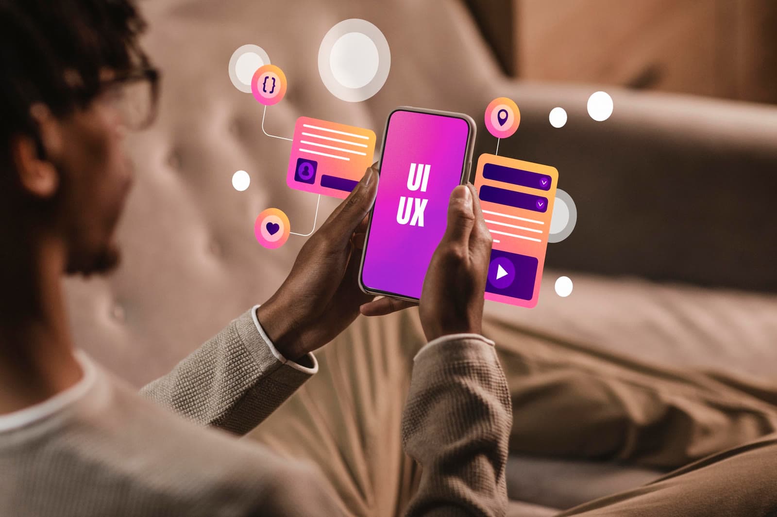Man holding a phone showing interface elements