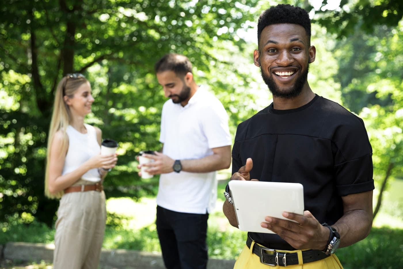Man holding a tablet in a park