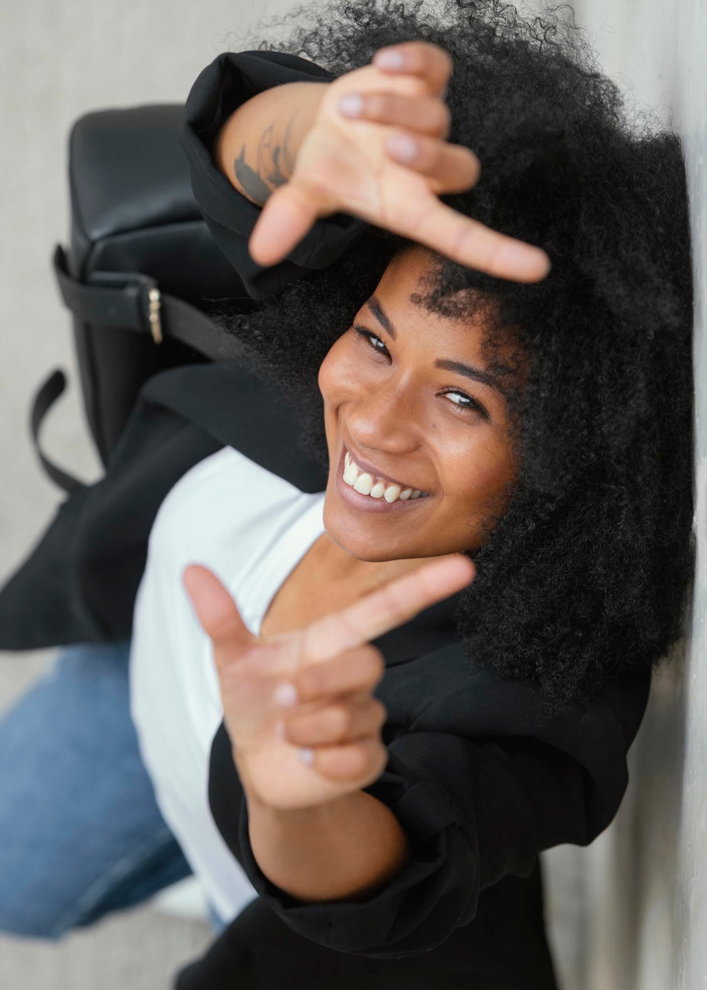 Woman framing her face with her fingers